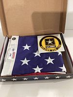 Folded Valley Forge American flag and Army decal inside original box