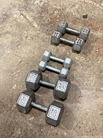 Three pairs of hex dumbbells arranged by size