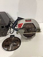 Saw, case, extra blade visible