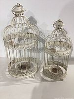 Both metal birdcage candle holders side by side