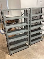Two grey metal shelving units side by side