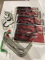 Four packaged JobSmart storage hook sets with loose hooks visible