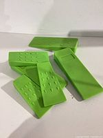 All six green AR-PRO felling wedges showing different sizes and grip teeth