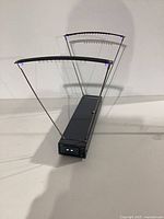 Overall view of velocity meter showing housing and curved sensor arms