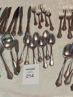 overview of assorted flatware showing knives, spoons, forks and ladle