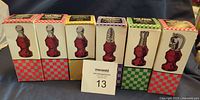 Front view of six boxed chess piece bottles