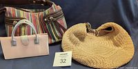 All three handbags grouped: striped St. Johns Bay shoulder bag, pink satin mini bag, beige crochet The Sak bag