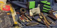 Full lot overview with socks, gloves, belt, knives, watches, sharpening stones