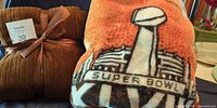 Both throw blankets side by side, showing brown ribbed throw and Super Bowl XVIII design