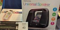 Front of boxes: Memorex Universal Speaker and CarMD diagnostic tool