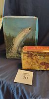 Two boxed Avon decanters; box art shows leaping trout and hunting scene