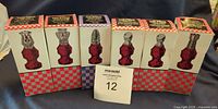 Six boxed Avon Chessmen bottles displayed front view