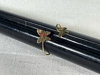 Ring on mandrel showing size and butterfly design