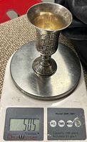 Cup on scale reading 50.5 grams