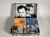 Open briefcase showing interior cast photo and two season slipcases