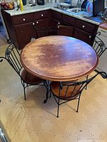 table with four matching chairs showing overall design and wear