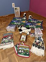 Full lot overview showing placemats, ceramic pieces, boxed items, linens and clock