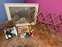 Group shot showing all items including framed art, accordion rack, sculpture in cube, tray with drinkware, blocks and tiles