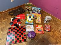 Group shot showing all board games, checkers set, Funko Pop figure, DVD and tote