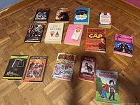 All fifteen paperbacks laid out on floor