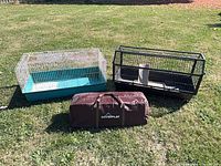 Two tabletop small-animal cages and Coverplay carry bag shown on grass