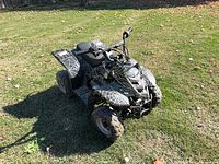 Full view of black/gray spiderweb camo youth ATV on grass