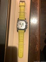 Front of wristwatch in box showing dial, strap and case