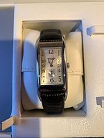 Front view of Gruen Curvex watch on cushion inside box