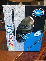 Front of retail box showing Pfizer Racing Team branding and globe inside window