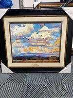 Front view of framed canvas showing artwork, frame, and protective corner covers