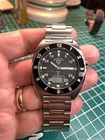 Front view showing dial, bezel, hands and digital display