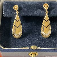 Pair of 10K gold diamond drop earrings in display case
