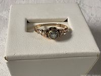 Front view of ring showing white sapphire and seed pearls