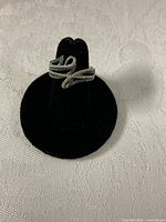 Front view of bypass 14K gold ring showing diamond and blue stone rows