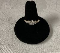 Ring front view showing three-stone diamond setting