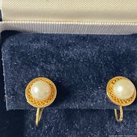 Front view of both pearl earrings in box