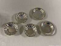 Five silver dishes front view showing shapes and rims