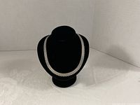 Necklace on black display bust full view