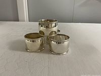 Four sterling silver Birks napkin rings grouped together