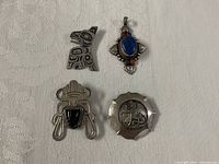 All four silver jewellery items together