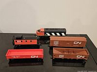 Group shot of locomotive, caboose and two freight cars