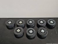 Eight pucks front view showing logos