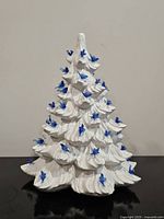 Front view of white ceramic Christmas tree with blue birds