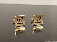 front view showing L monogram on both cufflink faces