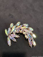 Front view of curved aurora borealis rhinestone brooch
