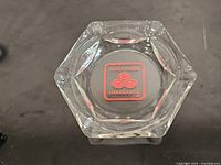 Top view of hexagonal glass ashtray displaying State Farm Insurance logo