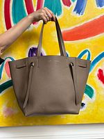 Front view of Celine taupe tote with handles and side straps