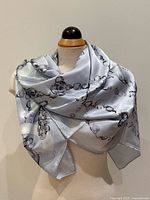 Scarf draped on mannequin showing overall size, colour and print