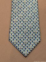 Front view of Hermes tie showing full rabbit and carrot pattern