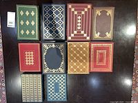 Top view of 10 leather-bound books showing gilt covers